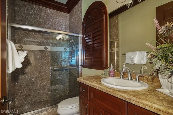 a bedroom with bed and glass windows