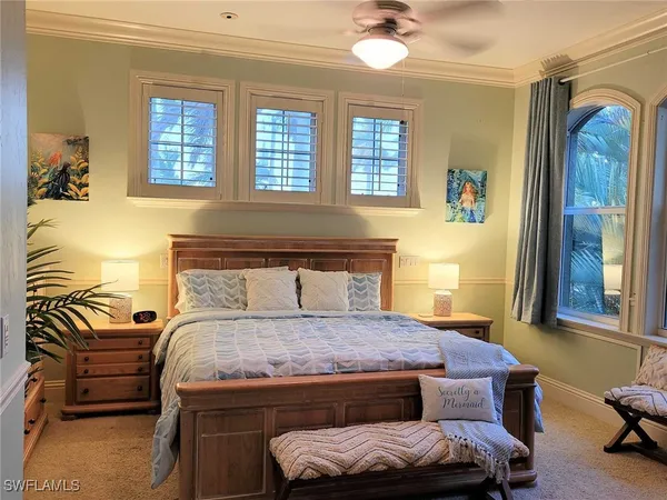 a bedroom with a bed and glass windows