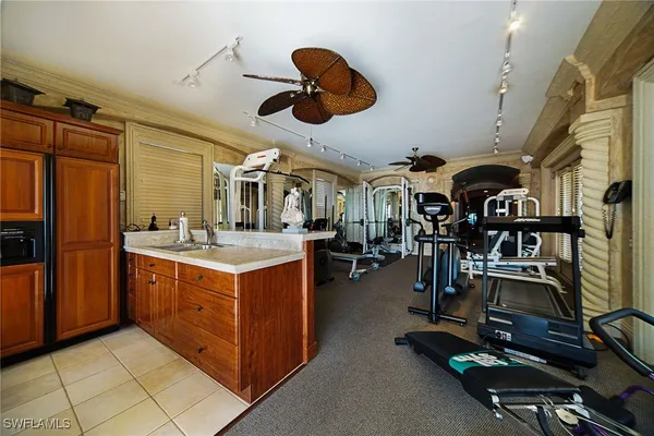 a bedroom with a bed a dresser and potted plants
