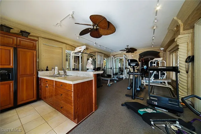 a bedroom with a bed a dresser and potted plants