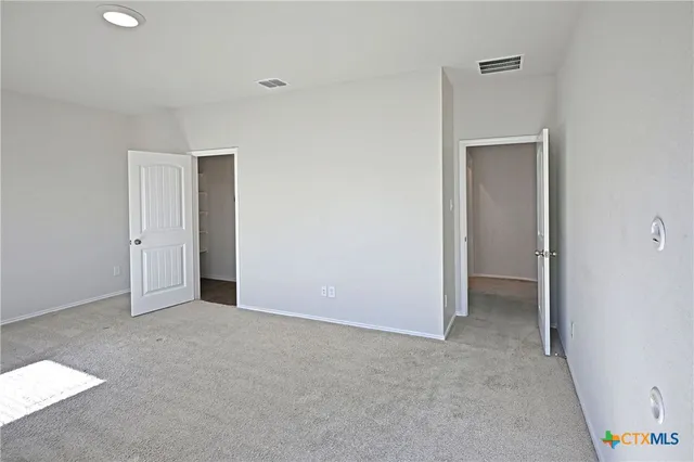 a view of an empty room and closet