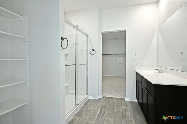 a bathroom with a glass shower door and a bathtub