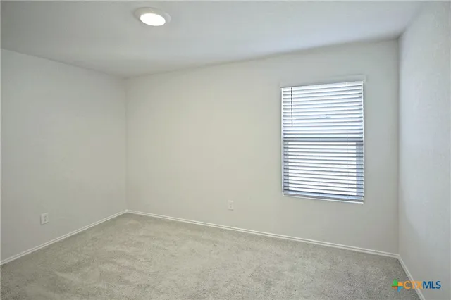 a view of a terrace with lawn chairs