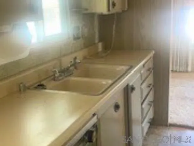 a bathroom with a sink and mirror