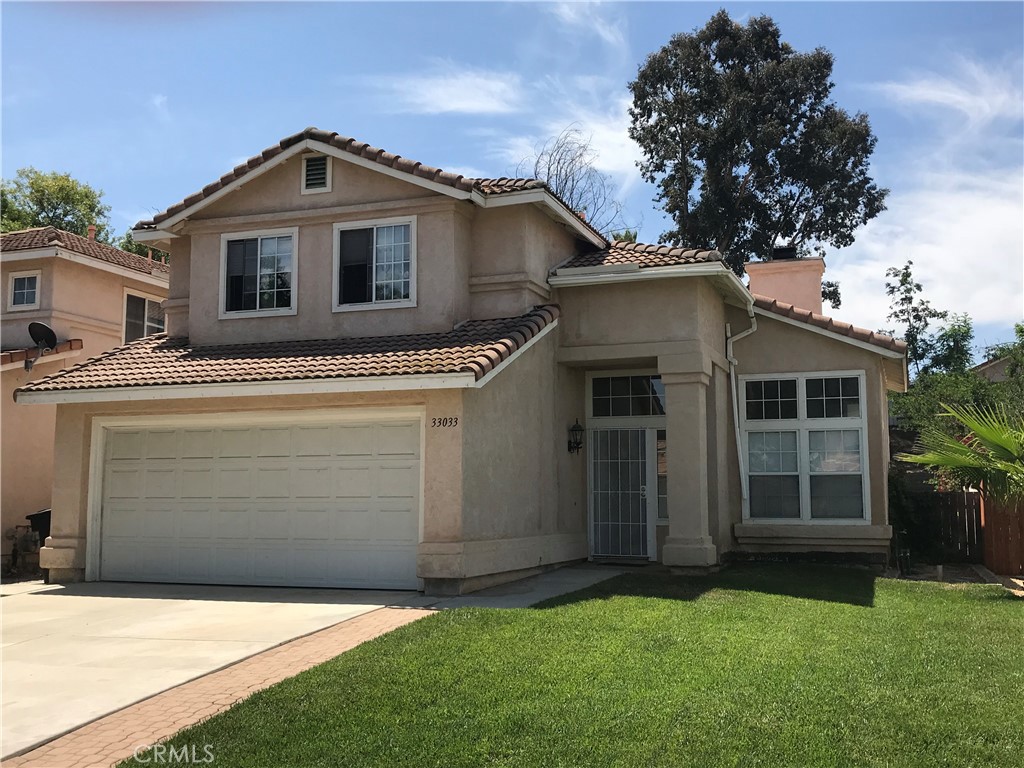 33033 Tulley Ranch Road Temecula, CA 92592 - Photo 1 of 14 a front view of a house with a garden