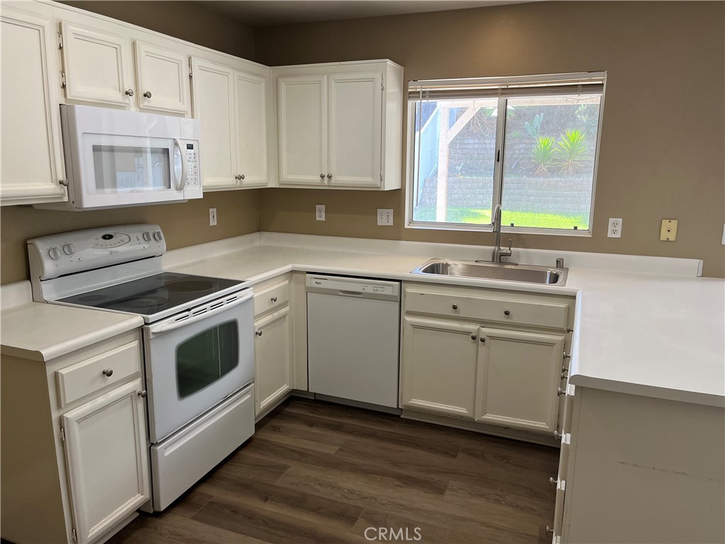 33033 Tulley Ranch Road Temecula, CA 92592 - Photo 3 of 14 a kitchen with white cabinets appliances and sink