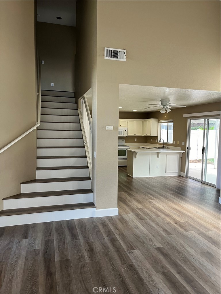33033 Tulley Ranch Road Temecula, CA 92592 - Photo 5 of 14 a view of a kitchen with wooden floor and a kitchen