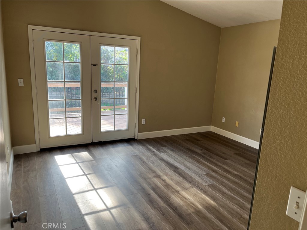 33033 Tulley Ranch Road Temecula, CA 92592 - Photo 6 of 14 wooden floor in an empty room with a window