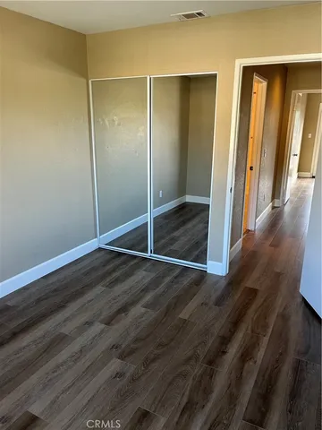 a view of a room with wooden floor and sliding glass door