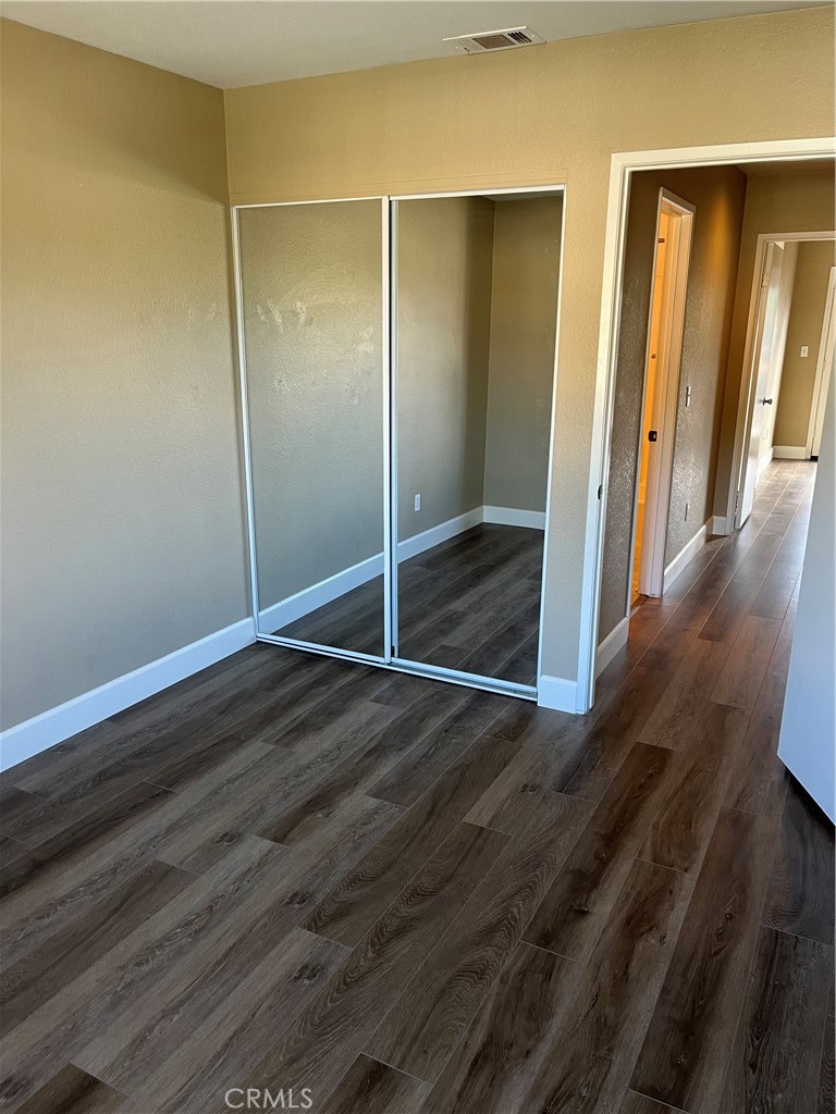 33033 Tulley Ranch Road Temecula, CA 92592 - Photo 7 of 14 a view of a room with wooden floor and sliding glass door