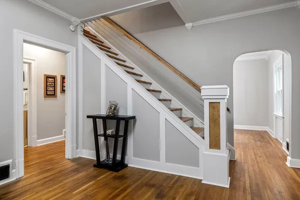 a view of entryway with wooden floor and stairs