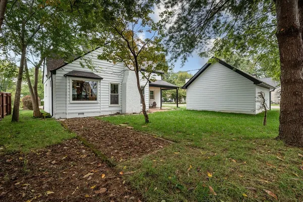 a view of a yard in front of a house with a small yard