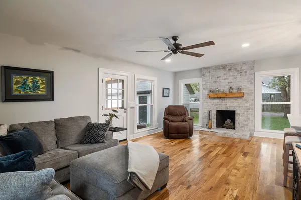 a living room with furniture a fireplace and a flat screen tv