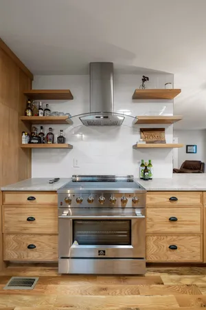 a stove top oven sitting inside of a kitchen