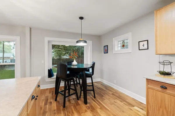 a view of a dining room with furniture window and wooden floor