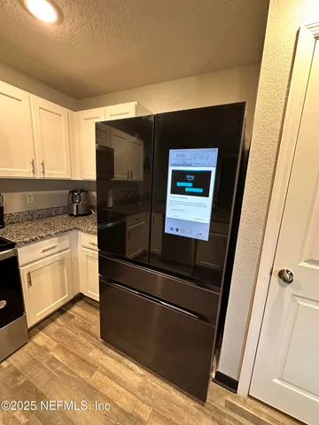 a kitchen with a refrigerator an oven