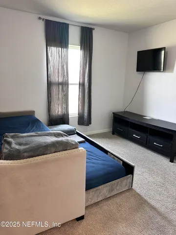 a bedroom with a bed and window