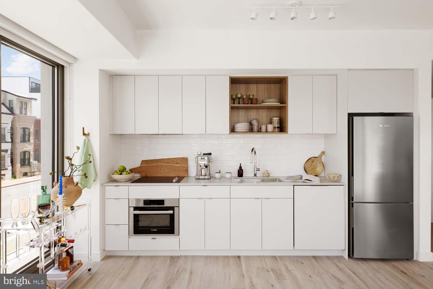 1 Florida Avenue Northeast, Unit 501 Washington, DC 20002 - Photo 4 of 14 a kitchen with stainless steel appliances a stove a refrigerator and a sink