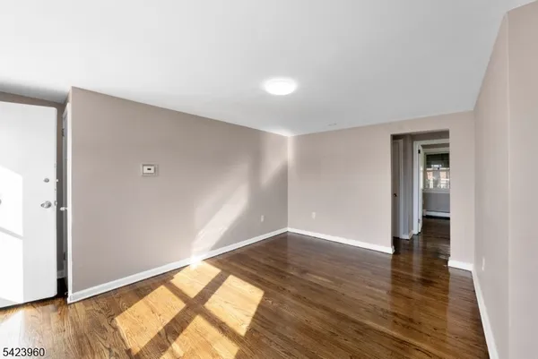 a view of an empty room and wooden floor