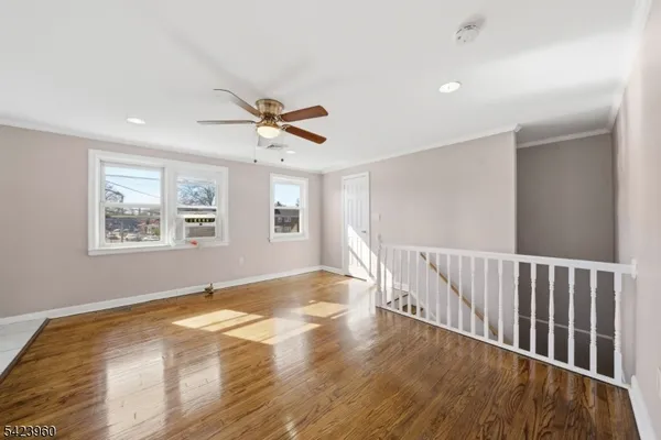 a view of a livingroom with wooden floor and a window