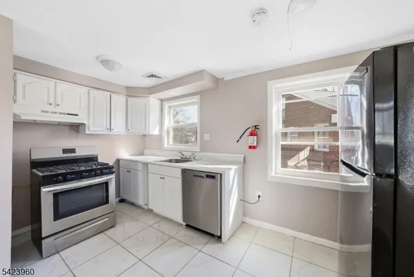 a kitchen with a stove a sink and a microwave