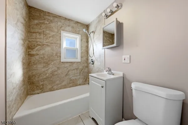 a bathroom with a sink a toilet and bathtub