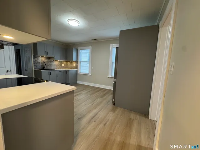 a kitchen with stainless steel appliances a refrigerator and a stove