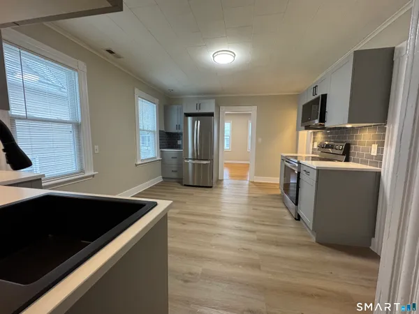 a kitchen with stainless steel appliances granite countertop a sink and a stove