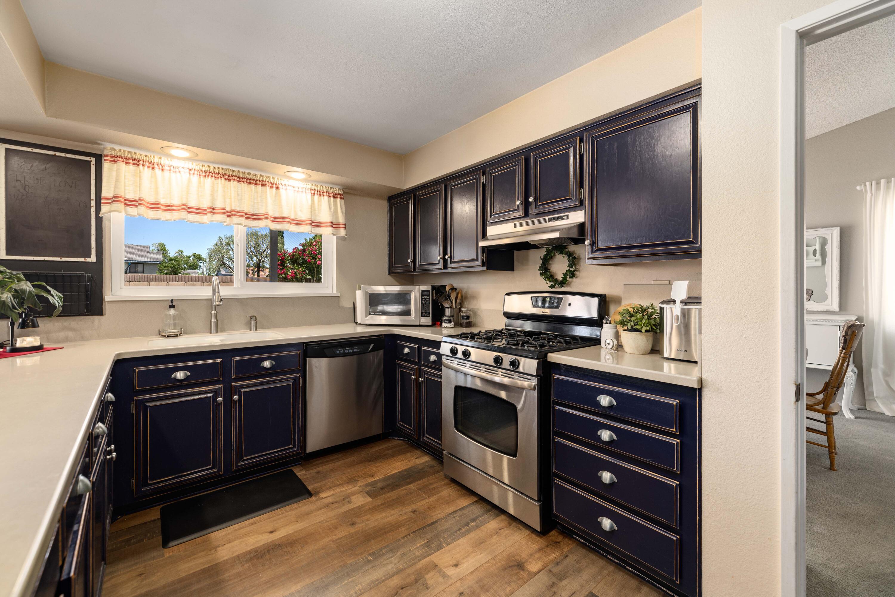 2833 Springfield Place Lancaster, CA 93536 - Photo 13 of 37 a kitchen with stainless steel appliances granite countertop a stove a sink and a microwave