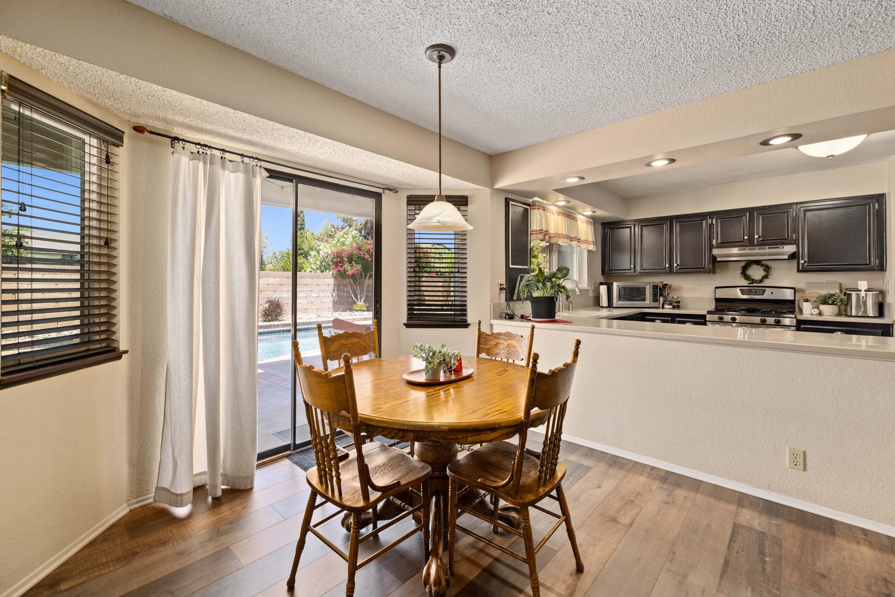 2833 Springfield Place Lancaster, CA 93536 - Photo 14 of 37 a dining room with stainless steel appliances granite countertop furniture and a kitchen view