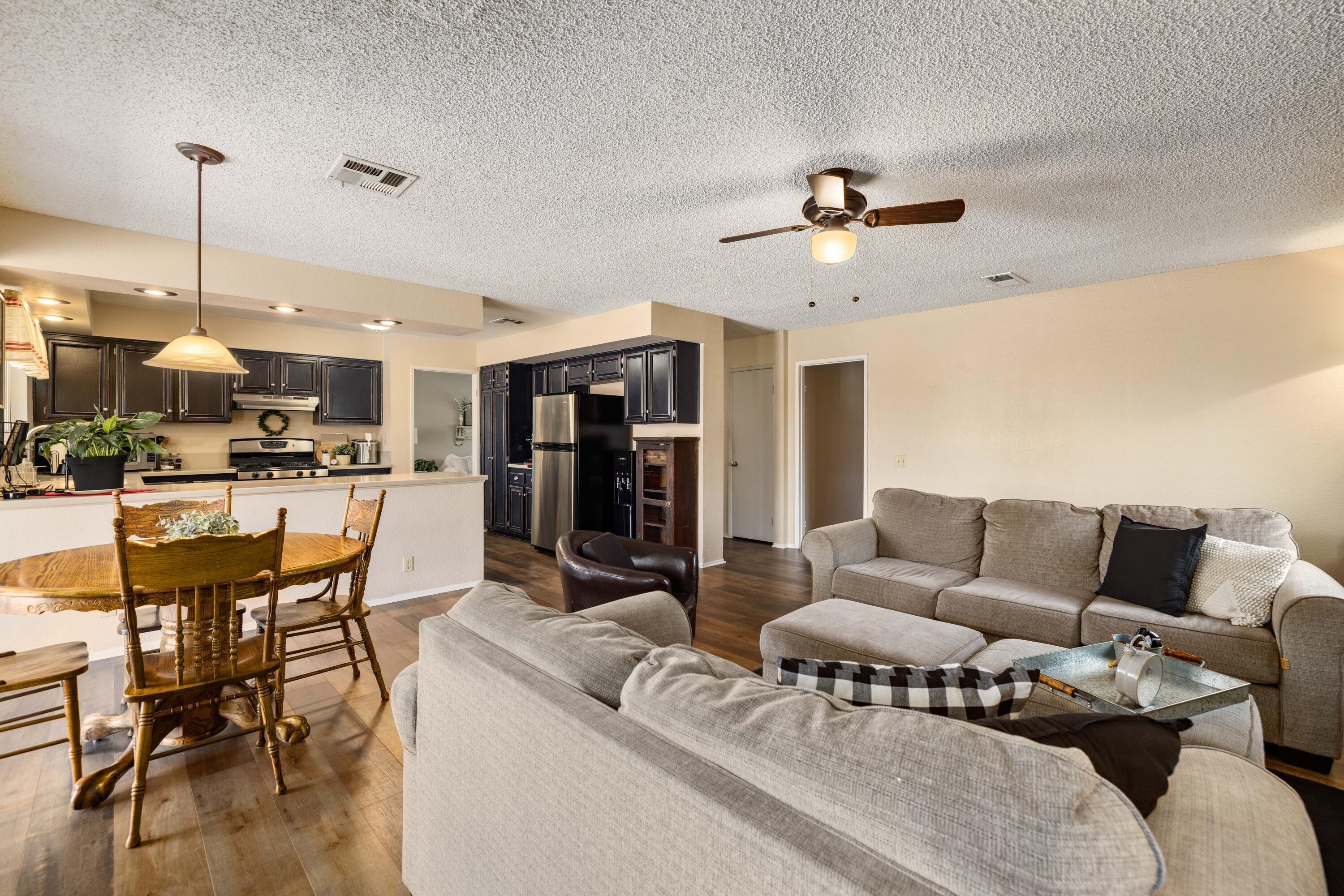 2833 Springfield Place Lancaster, CA 93536 - Photo 15 of 37 a living room with furniture and kitchen view