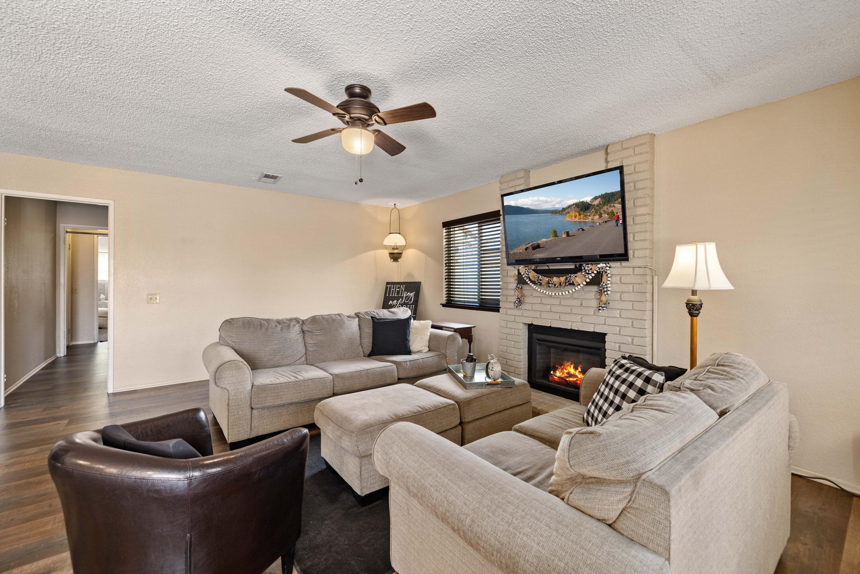 2833 Springfield Place Lancaster, CA 93536 - Photo 18 of 37 a living room with furniture a fireplace and a flat screen tv