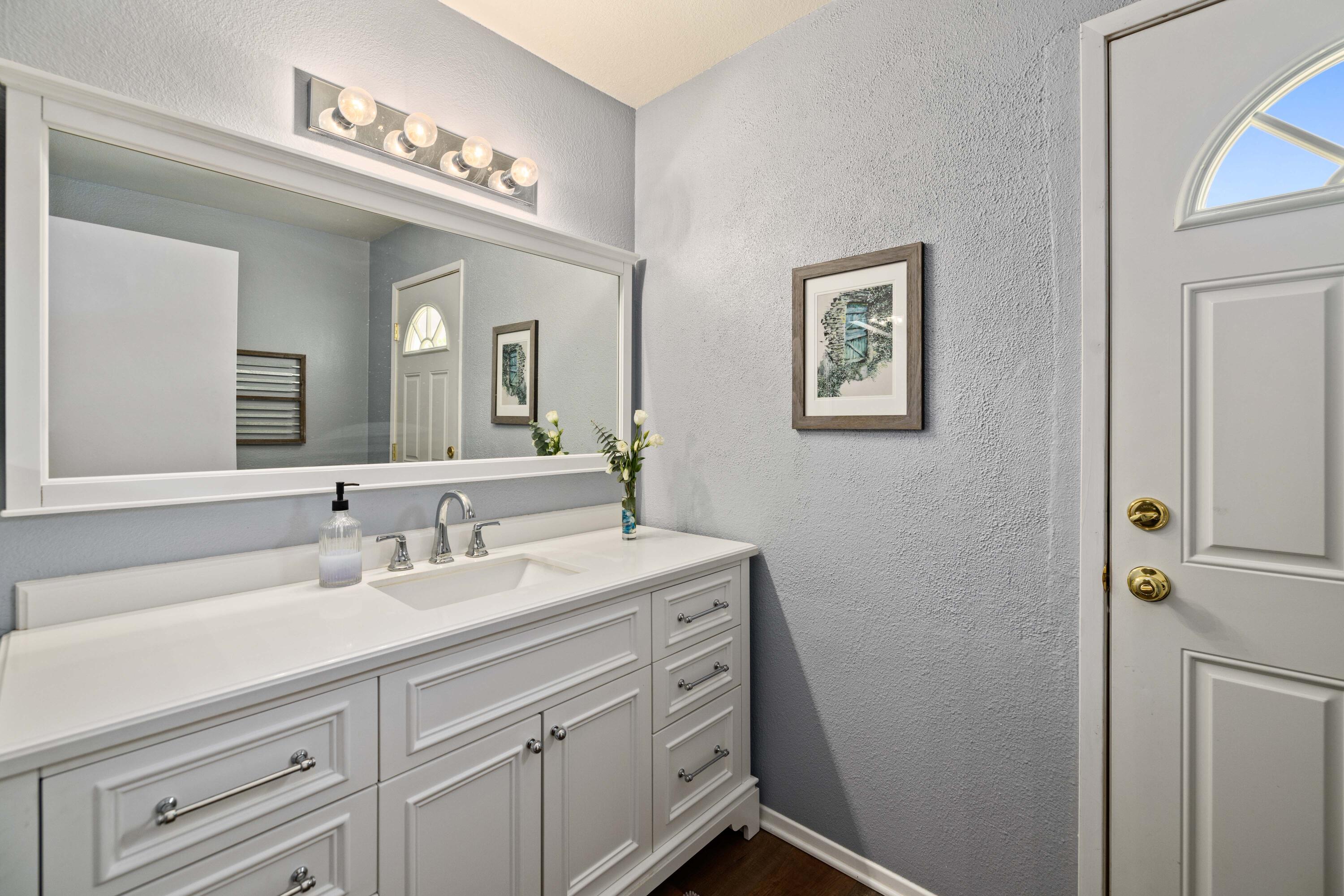2833 Springfield Place Lancaster, CA 93536 - Photo 21 of 37 a bathroom with a double vanity sink and a mirror
