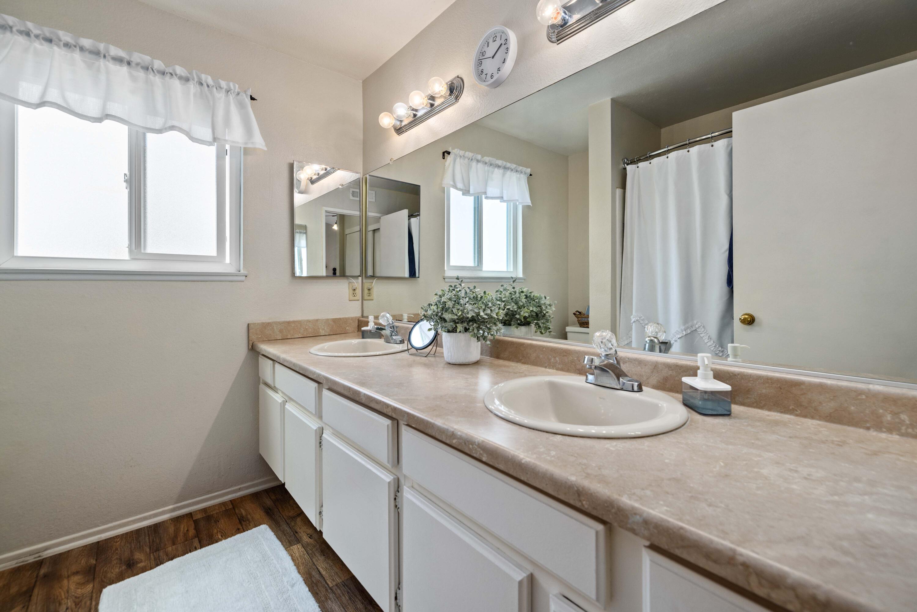 2833 Springfield Place Lancaster, CA 93536 - Photo 30 of 37 a bathroom with a granite countertop sink a mirror and a window