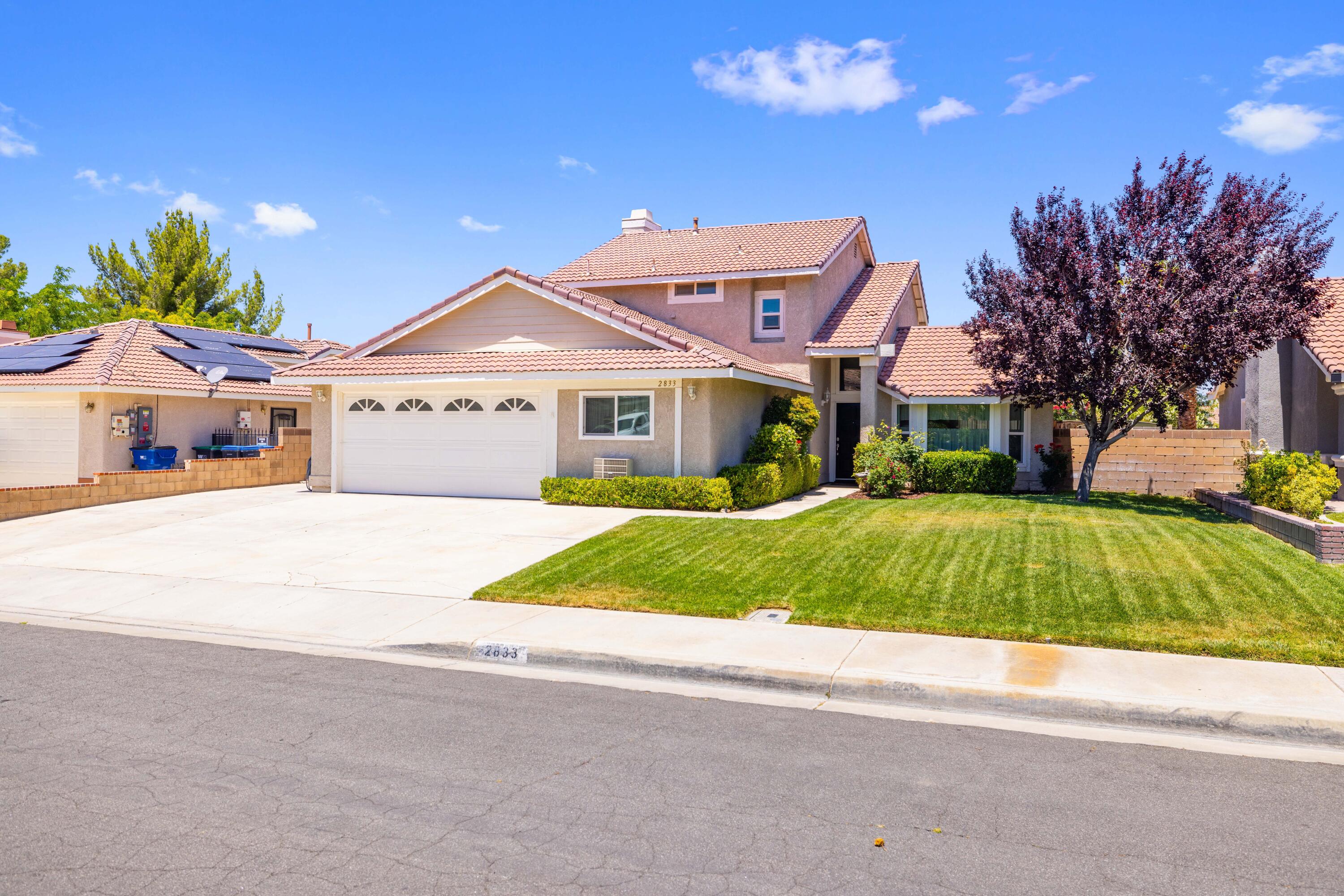 2833 Springfield Place Lancaster, CA 93536 - Photo 3 of 37 a house with trees in the background