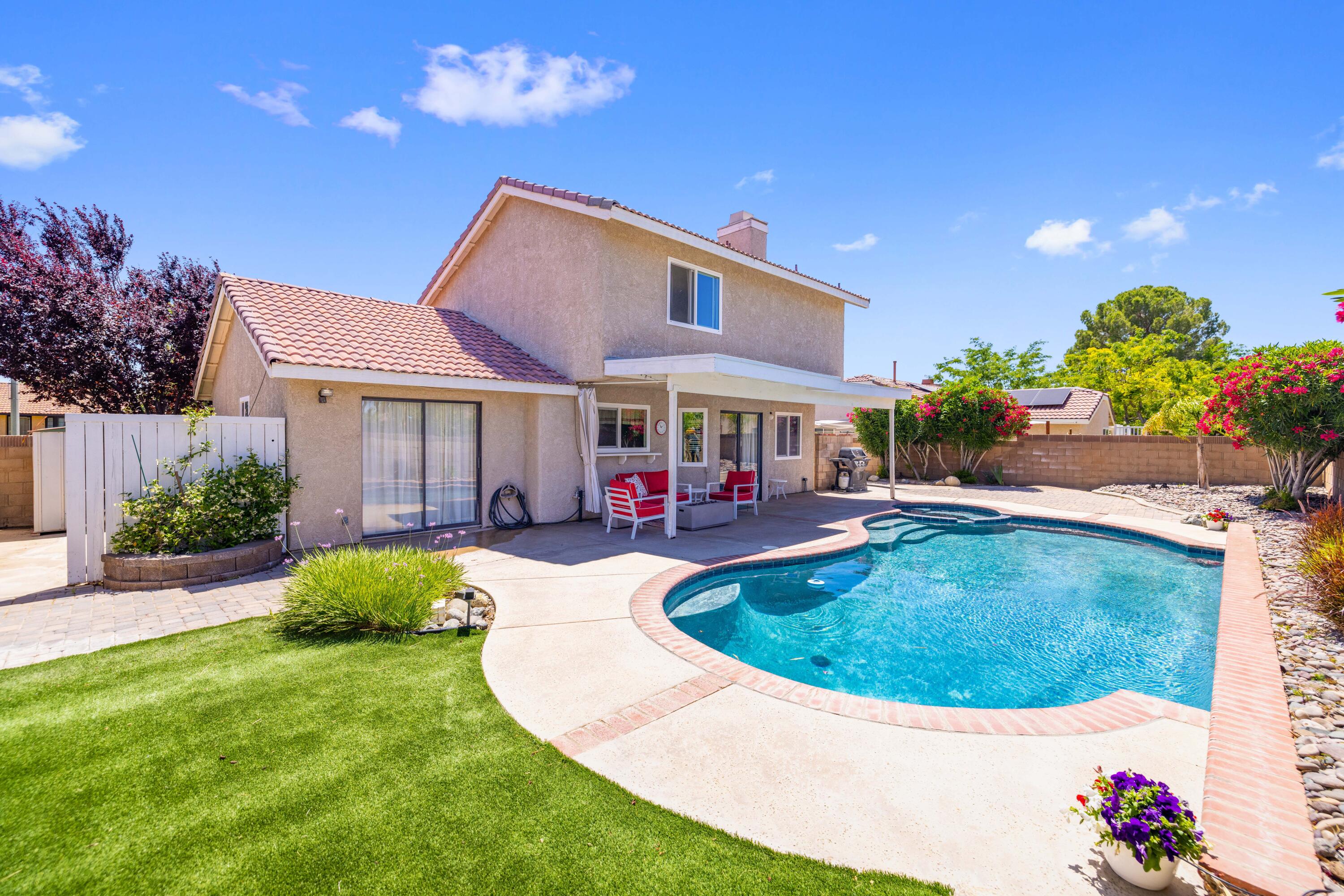 2833 Springfield Place Lancaster, CA 93536 - Photo 34 of 37 a view of a house with swimming pool and a yard