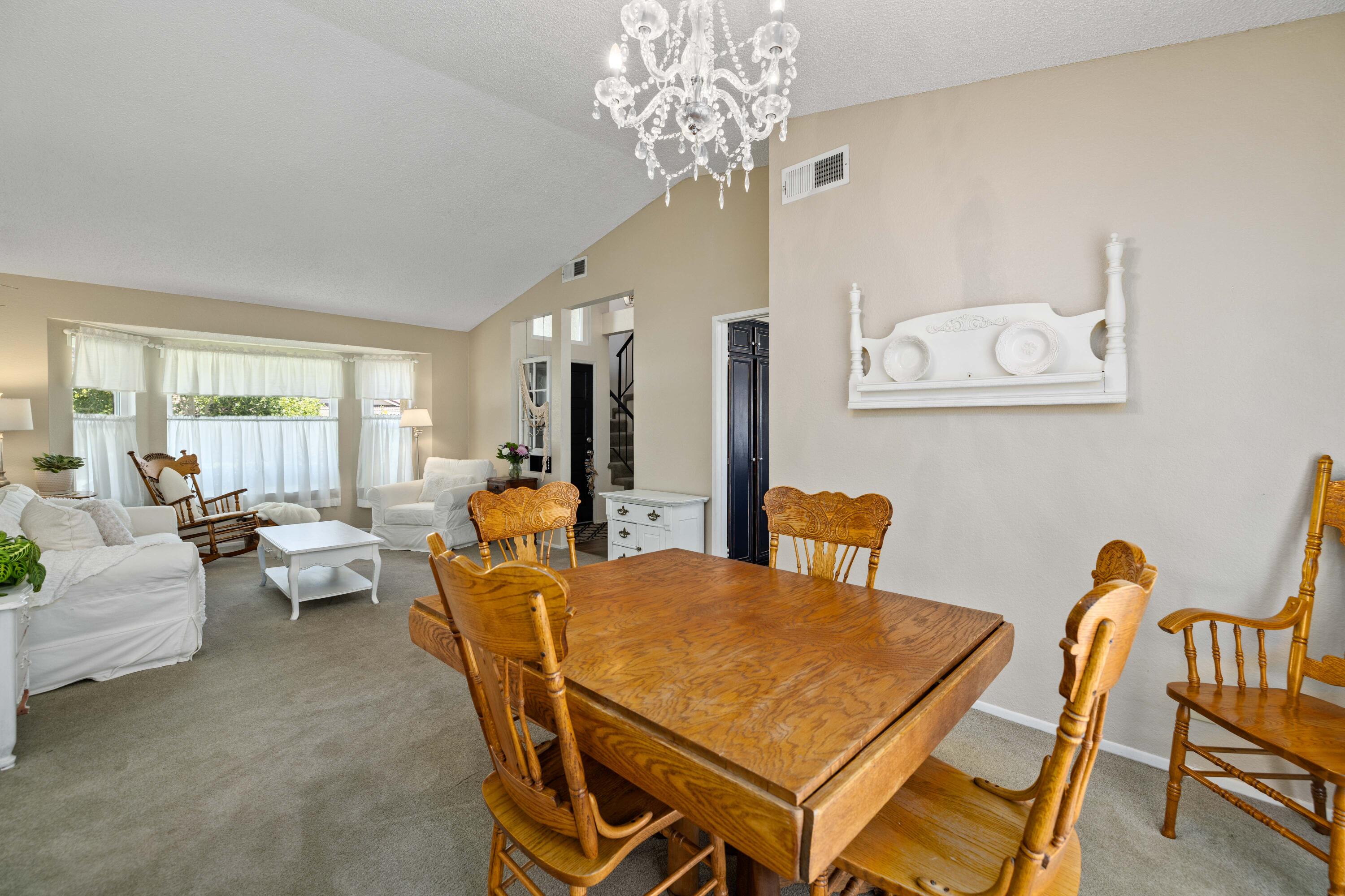 2833 Springfield Place Lancaster, CA 93536 - Photo 8 of 37 a living room with furniture a chandelier and a dining table