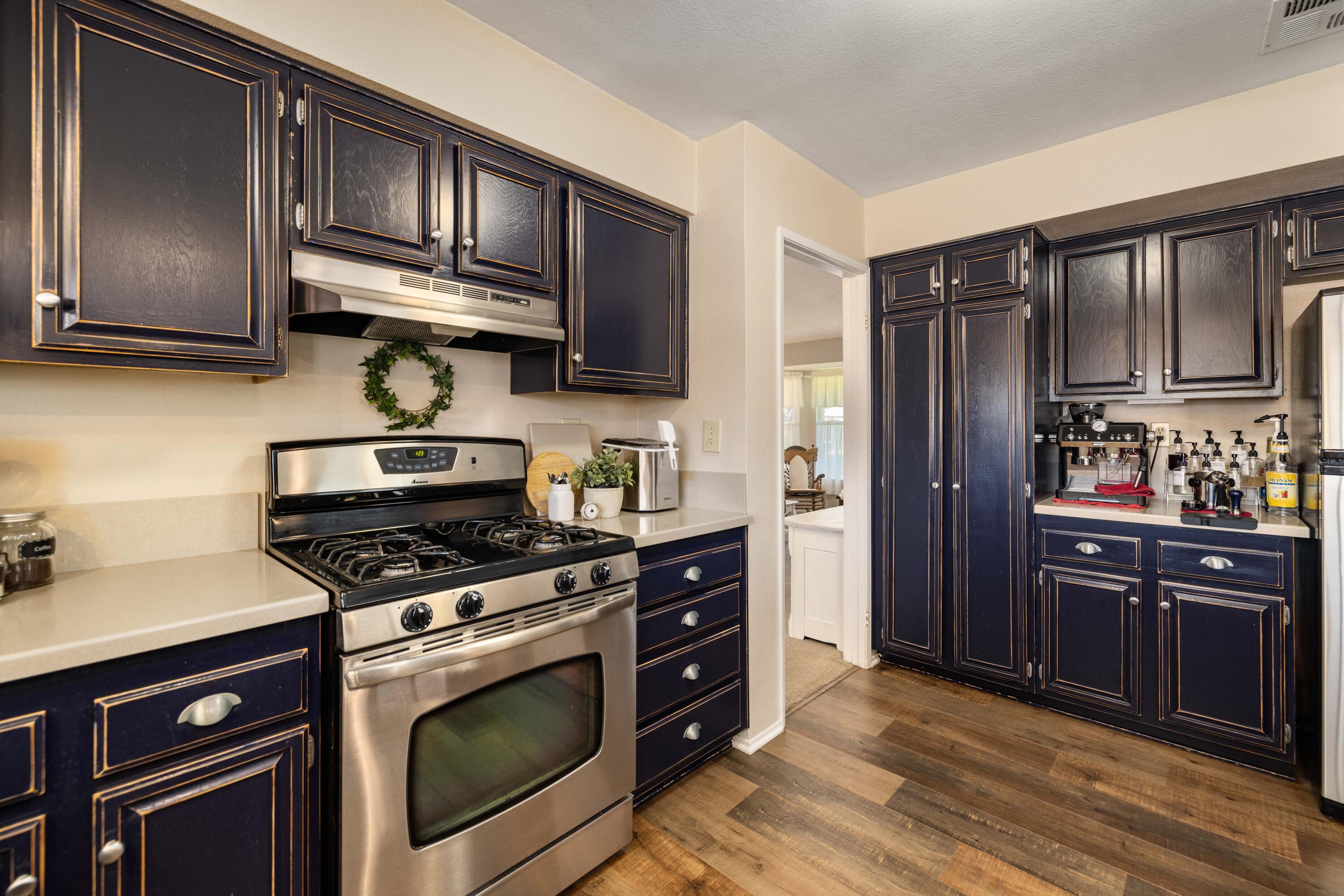 2833 Springfield Place Lancaster, CA 93536 - Photo 10 of 37 a kitchen with stainless steel appliances granite countertop a stove microwave and refrigerator