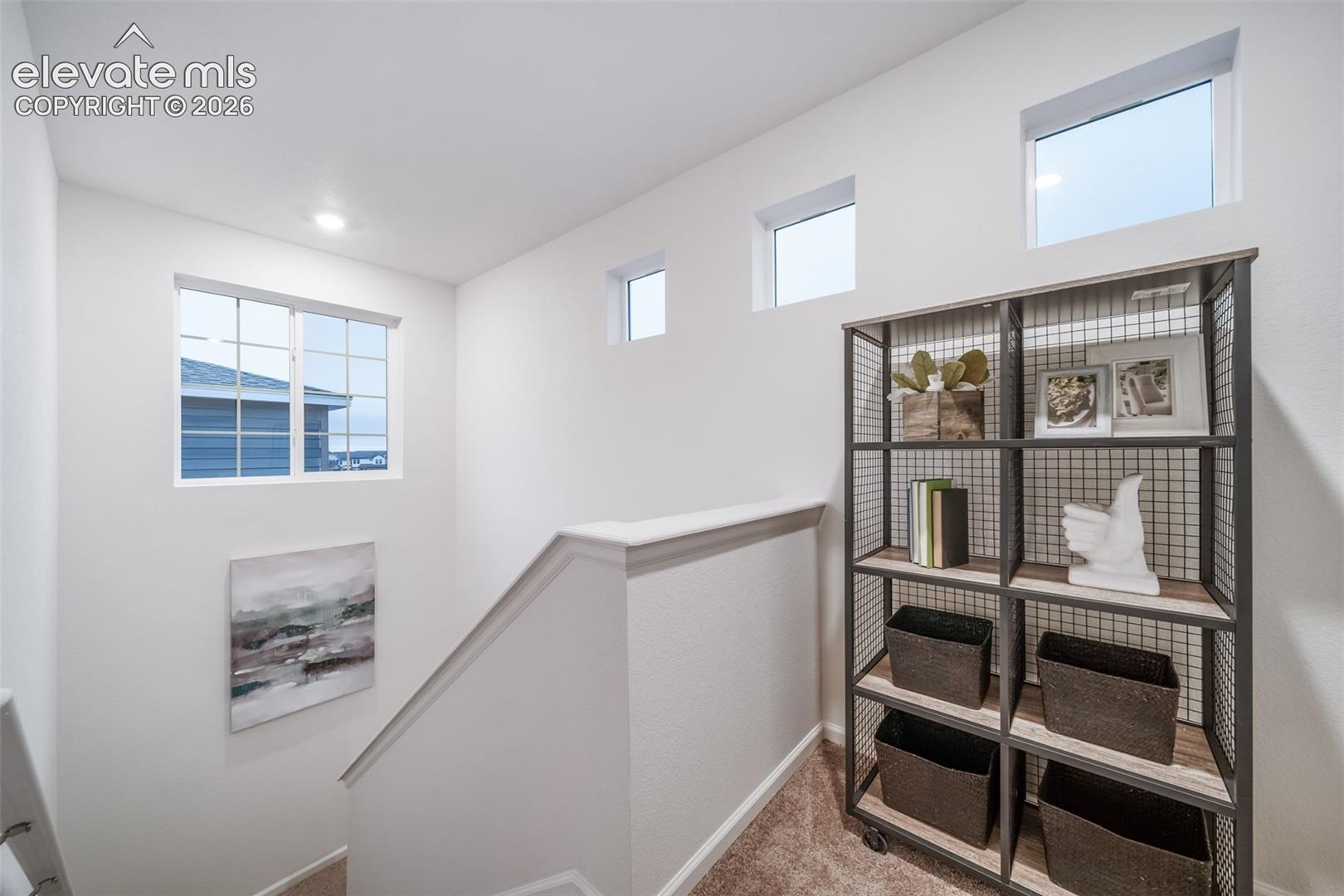 4936 Truscott Road Colorado Springs, CO 80925 - Photo 27 of 41 Staircase with light wall paint and multiple windows
*photos of a model home*