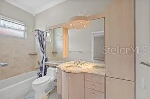 a bathroom with a double vanity sink mirror and toilet