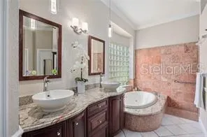 a bathroom with a granite countertop sink a toilet and a mirror