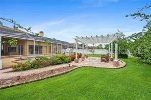 a view of a house with backyard and sitting area