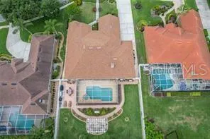 an aerial view of a house with garden space and street view