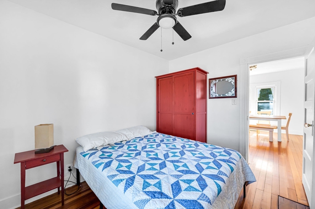 83 Mazarin Street Springfield, MA 01151 - Photo 20 of 25 a bedroom with a bed and wooden floor