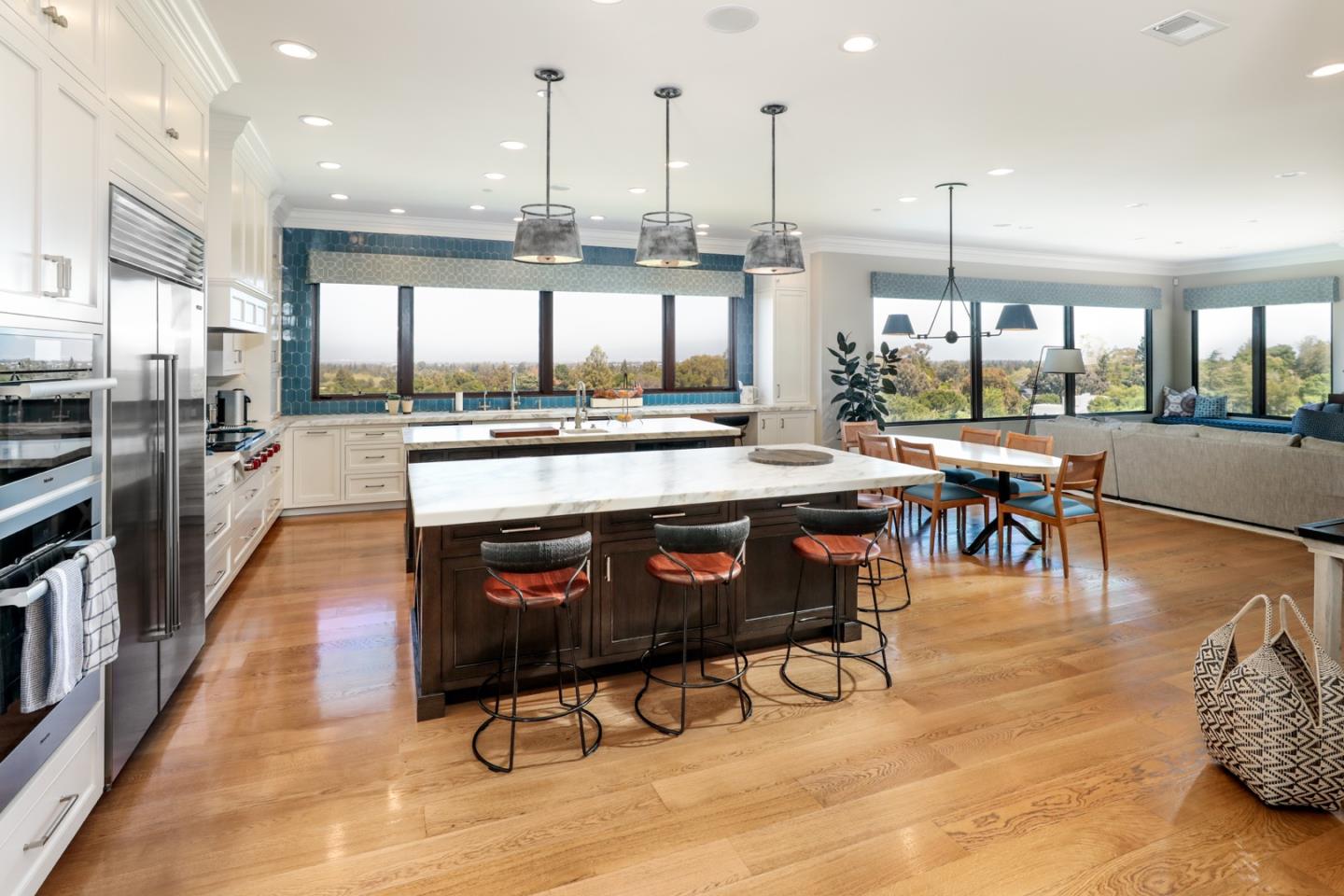 883 Robb Road Palo Alto, CA 94306 - Photo 27 of 33 a kitchen with stainless steel appliances granite countertop a stove top oven a kitchen island a dining table and chairs
