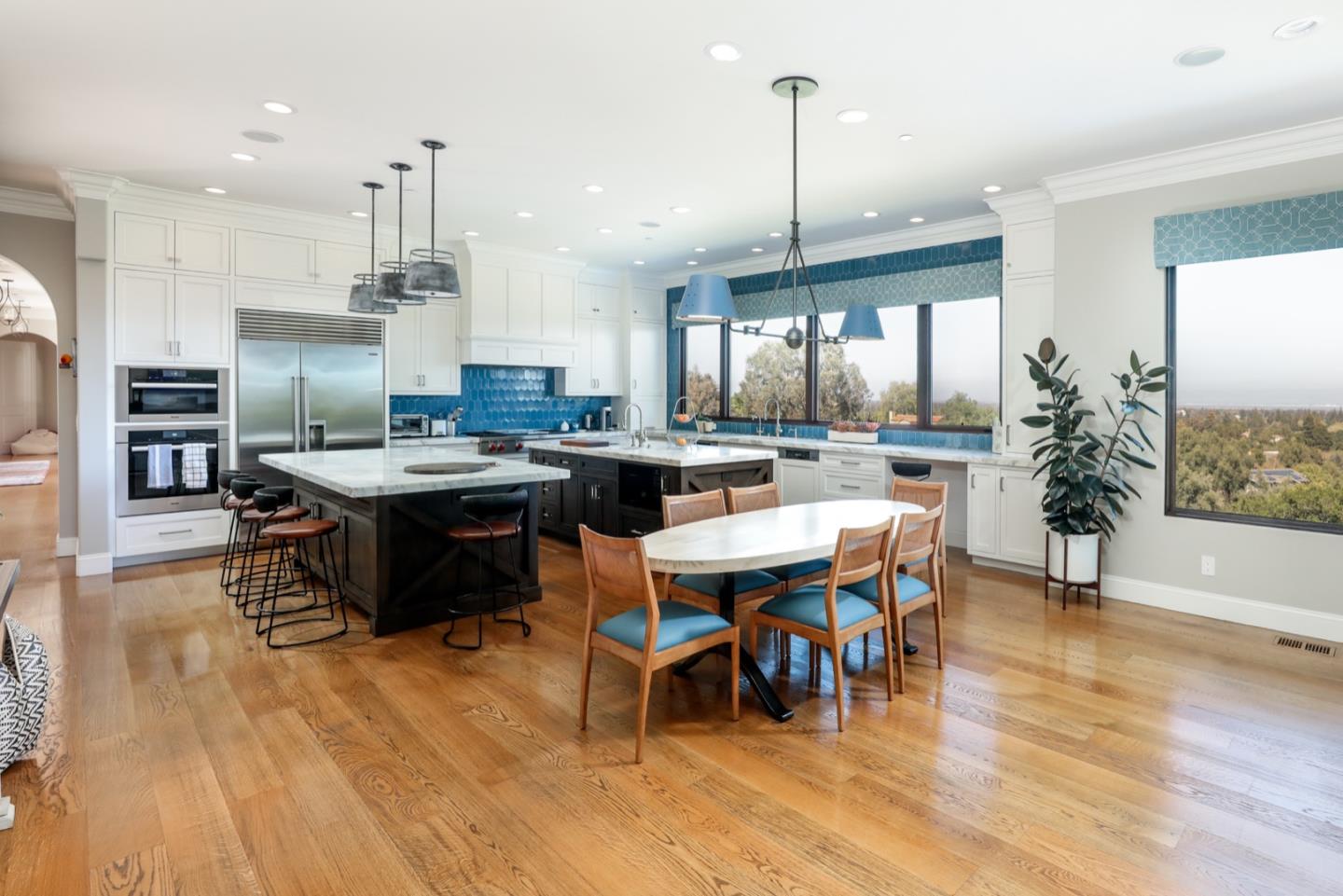 883 Robb Road Palo Alto, CA 94306 - Photo 30 of 33 a dining hall with stainless steel appliances kitchen island granite countertop a table chairs and a living room