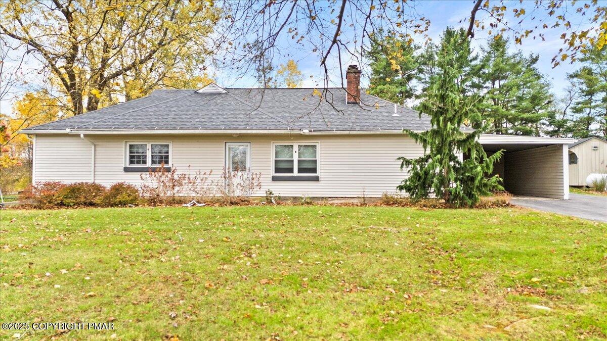a front view of house with yard and trees