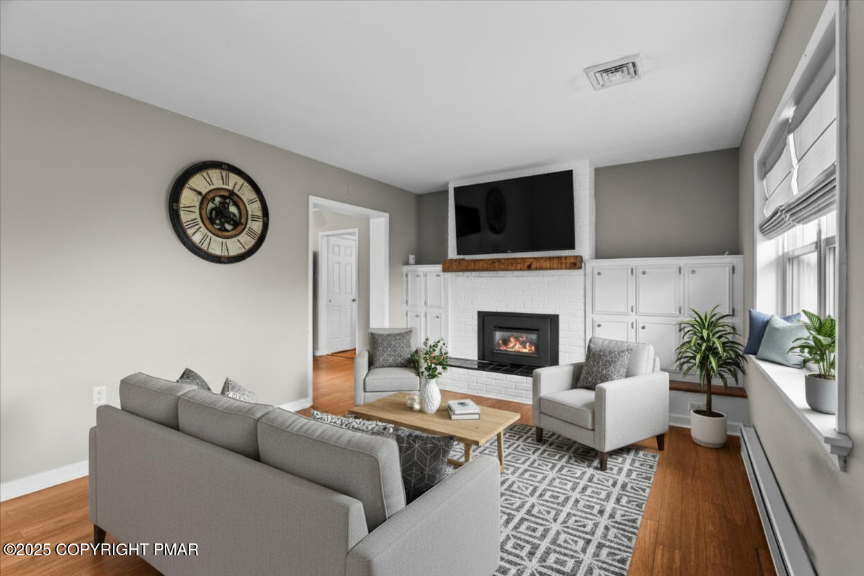 1215 Country Club Road Clarks Summit, PA 18411 - Photo 12 of 50 a living room with furniture a fireplace and a flat screen tv