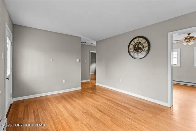 a view of a room with wooden floor