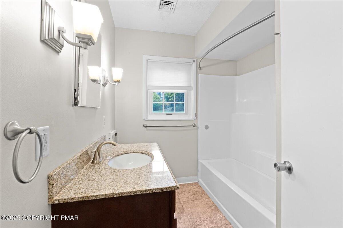 1215 Country Club Road Clarks Summit, PA 18411 - Photo 16 of 50 a bathroom with a granite countertop sink vanity mirror and bathtub